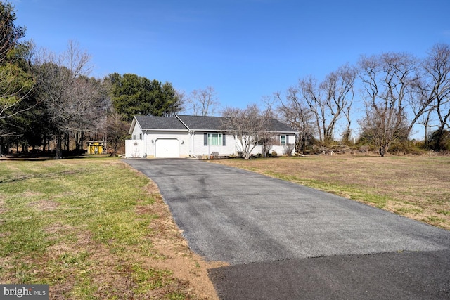 view of front of home featuring a garage, a front yard, and driveway