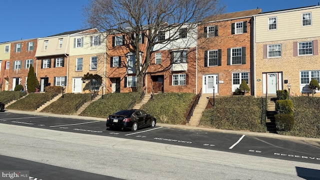 view of property with stairway and a residential view