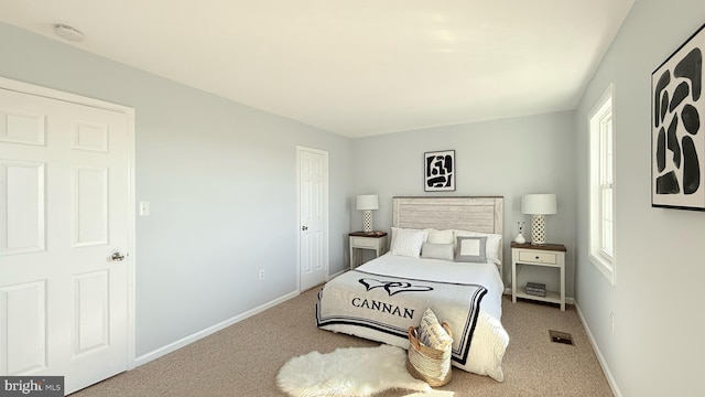 carpeted bedroom with baseboards and visible vents