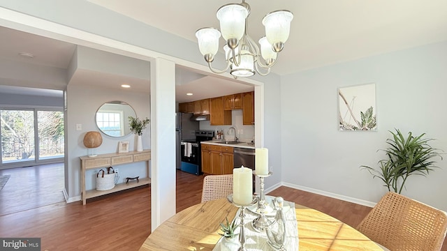 dining area featuring a notable chandelier, baseboards, dark wood-style flooring, and recessed lighting