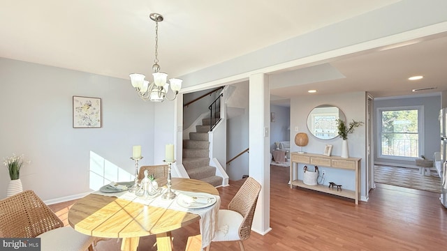 dining room featuring light wood-style floors, stairs, baseboards, and recessed lighting