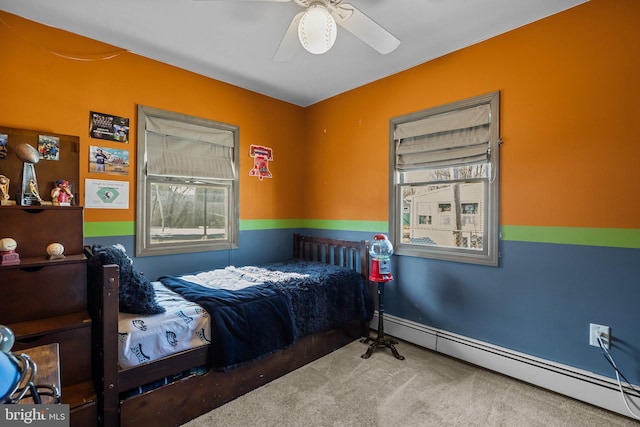 bedroom featuring a ceiling fan, carpet, and a baseboard radiator