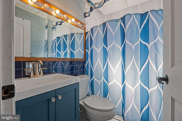 bathroom with toilet, a shower with shower curtain, tile walls, decorative backsplash, and vanity