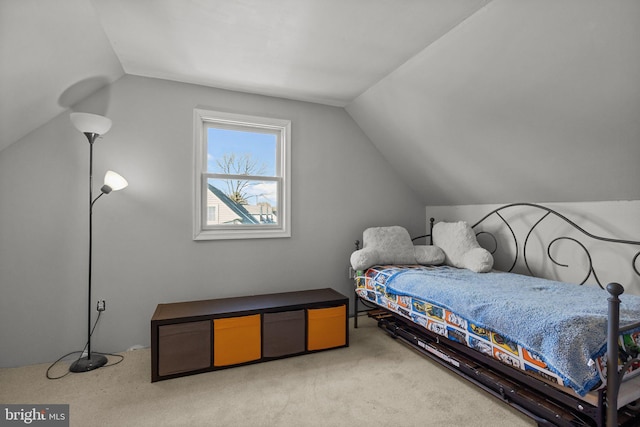 bedroom featuring vaulted ceiling and light carpet