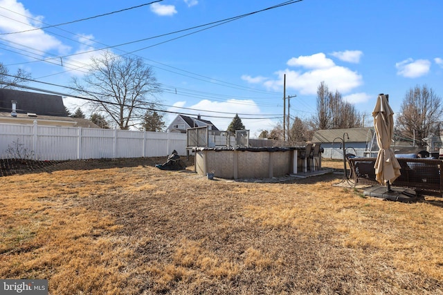 view of yard featuring a fenced in pool and fence