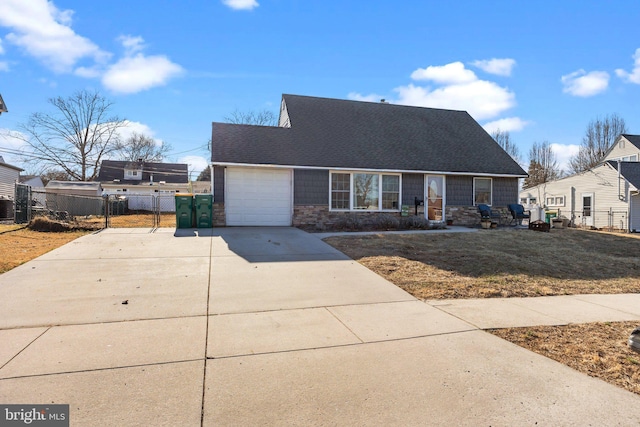 view of front of property with an attached garage, fence, central air condition unit, stone siding, and driveway