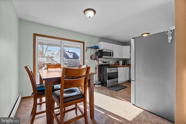 dining space featuring a baseboard heating unit and baseboards