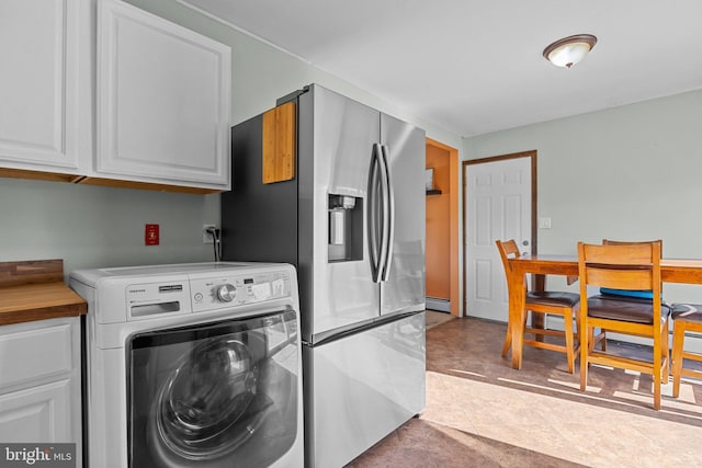 laundry room featuring cabinet space, washer / dryer, and a baseboard radiator