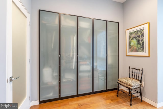 sitting room with wood finished floors and baseboards