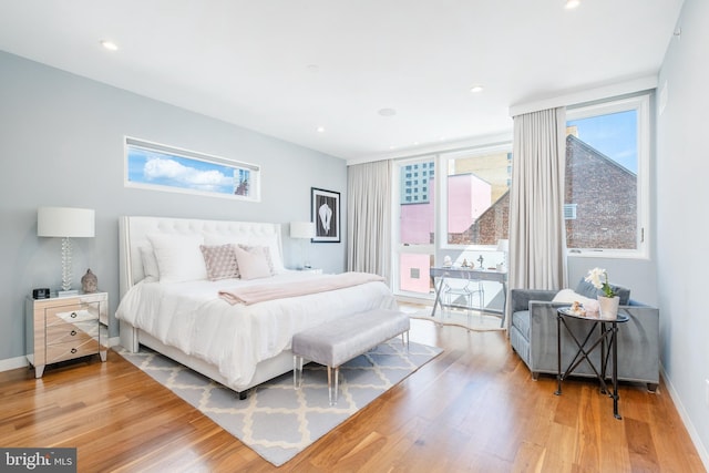 bedroom featuring light wood-type flooring, baseboards, and recessed lighting