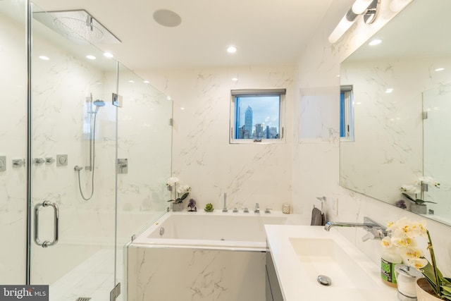 full bathroom with a garden tub, recessed lighting, vanity, tile walls, and a marble finish shower