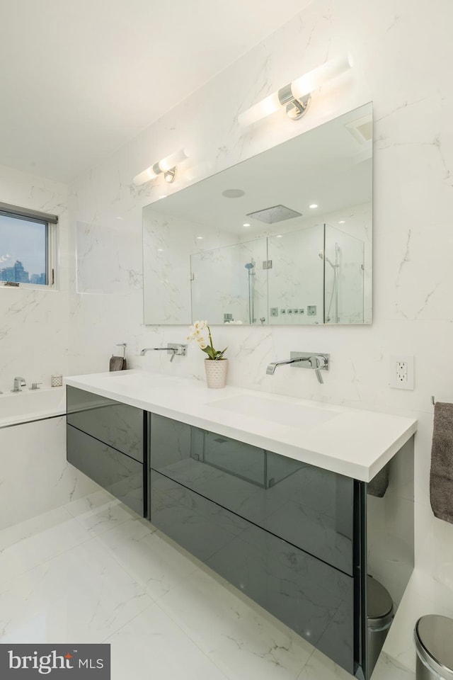 full bath featuring toilet, a sink, marble finish floor, a marble finish shower, and double vanity