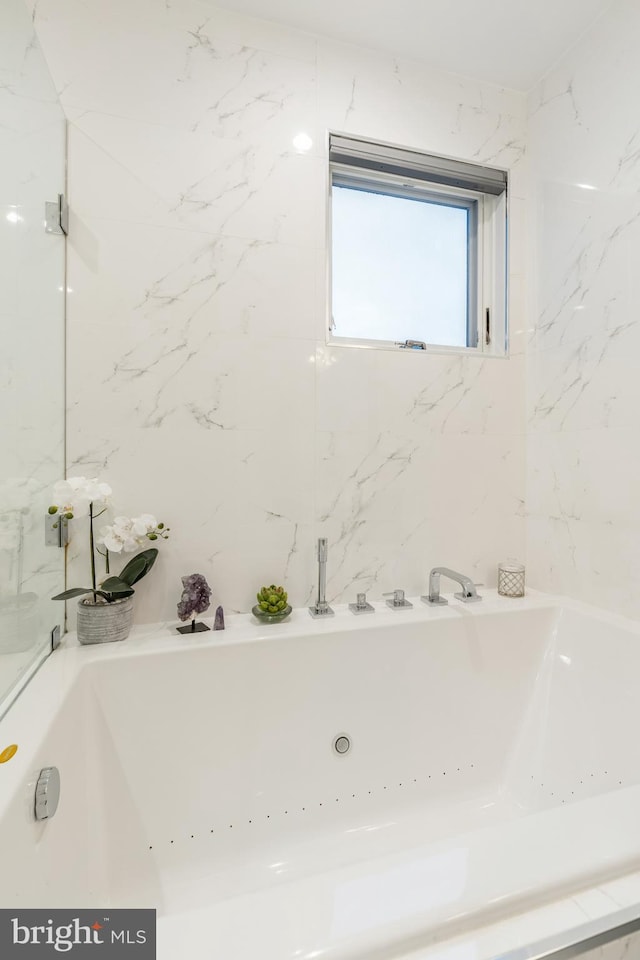 full bathroom with a whirlpool tub