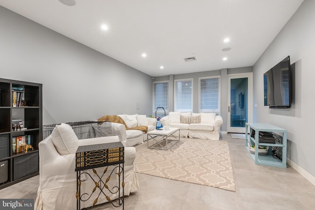 living room with baseboards, light tile patterned floors, visible vents, and recessed lighting