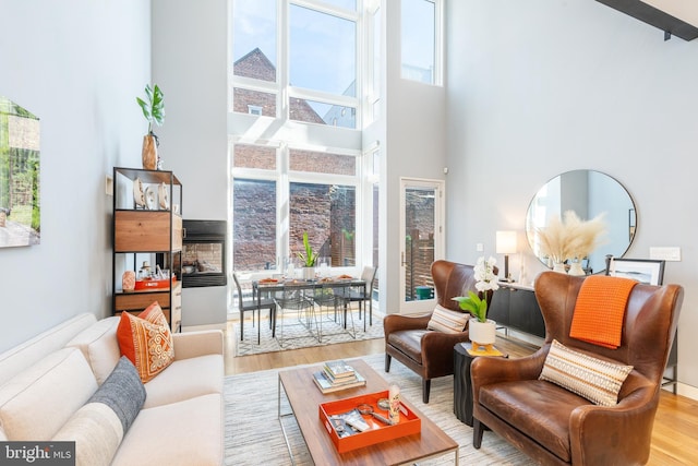 interior space with a towering ceiling and wood finished floors