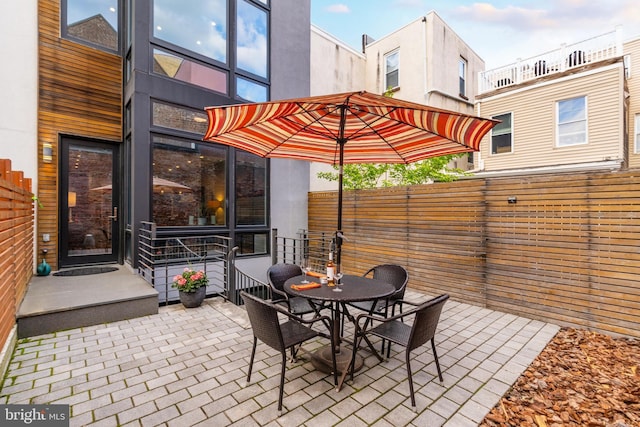 view of patio / terrace featuring outdoor dining area and fence