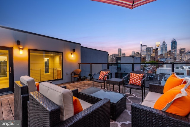 view of patio / terrace with a balcony, an outdoor hangout area, and a city view