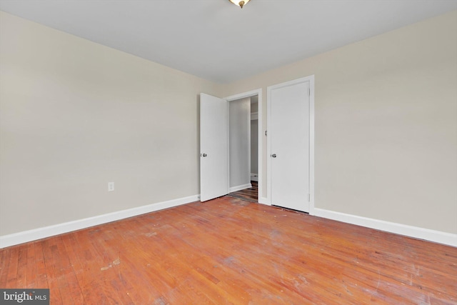 unfurnished bedroom featuring light wood-type flooring and baseboards