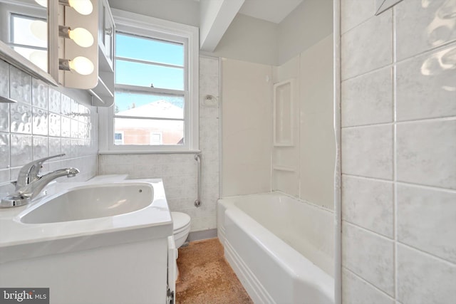 bathroom featuring tile walls, toilet, and vanity