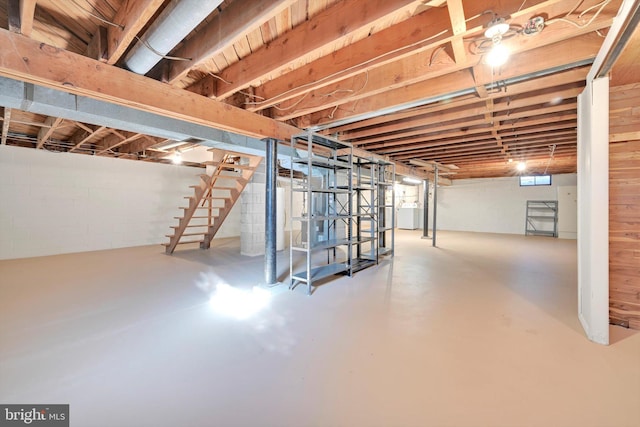 basement with water heater and stairway