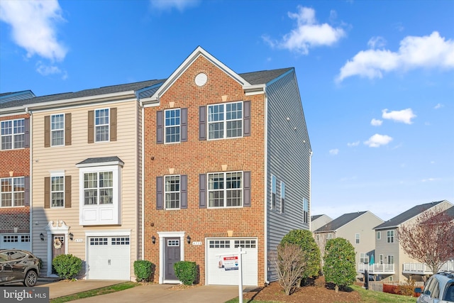 view of front of home with brick siding, driveway, and an attached garage