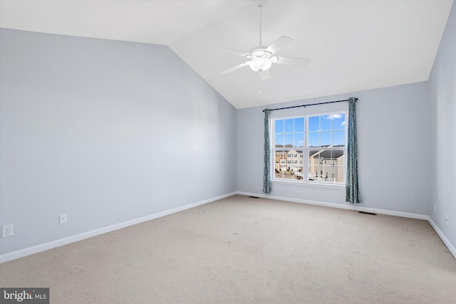 unfurnished room with baseboards, lofted ceiling, carpet, and a ceiling fan