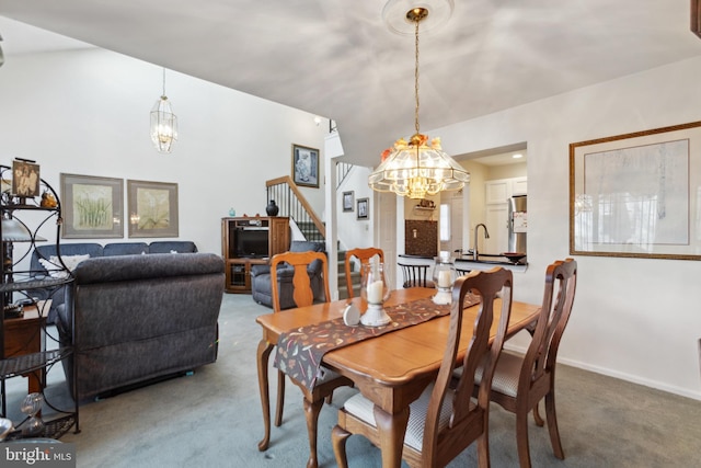 dining space featuring stairs, carpet floors, baseboards, and a notable chandelier