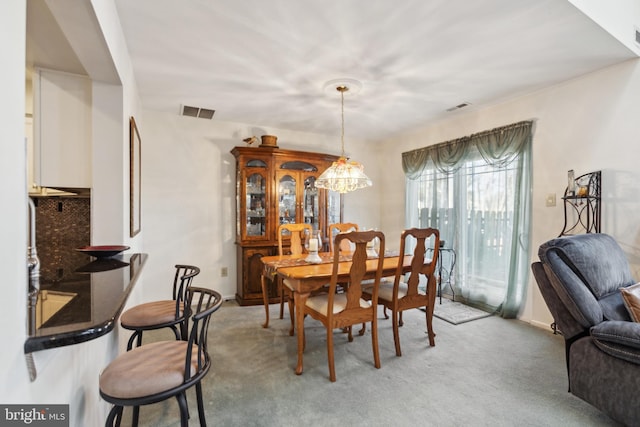 dining area with visible vents and light carpet