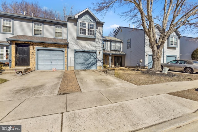 multi unit property featuring driveway and an attached garage