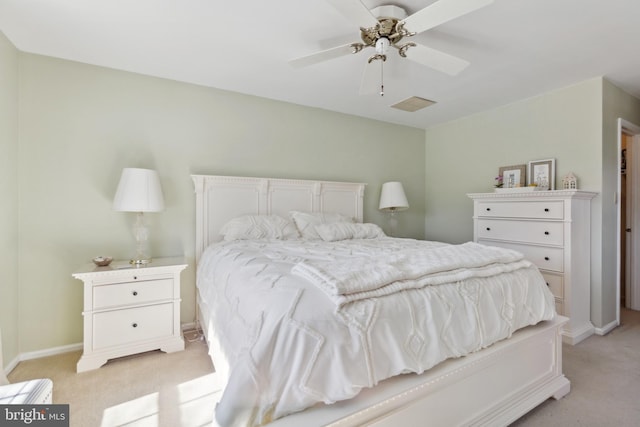 bedroom with baseboards, visible vents, and light colored carpet