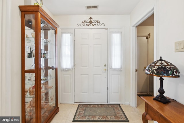 entrance foyer with visible vents and light tile patterned floors