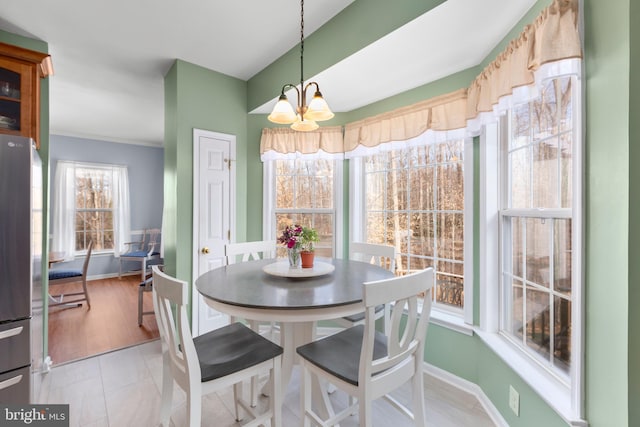 dining room with light tile patterned floors, a notable chandelier, and baseboards