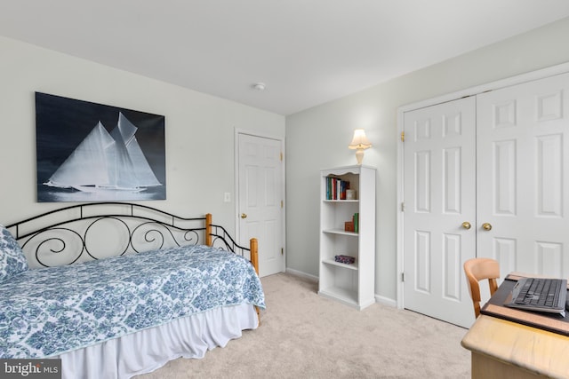 bedroom featuring a closet, carpet floors, and baseboards