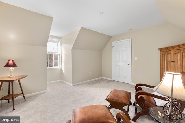 living area featuring light colored carpet, baseboards, and lofted ceiling