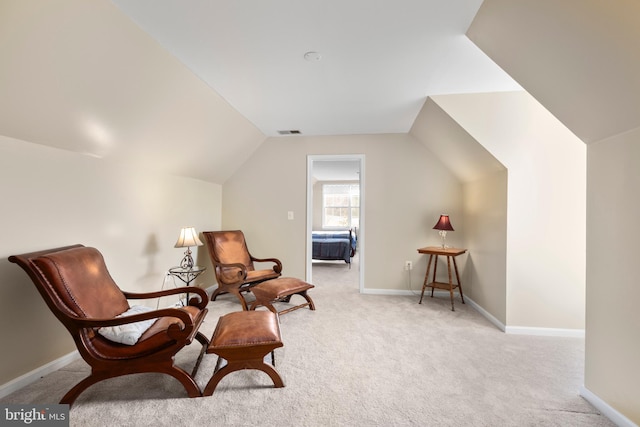 living area with visible vents, baseboards, lofted ceiling, and carpet