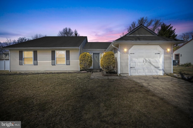 single story home with a yard, driveway, and an attached garage