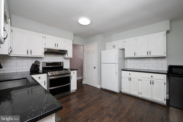 kitchen with white cabinets, under cabinet range hood, range with two ovens, and freestanding refrigerator