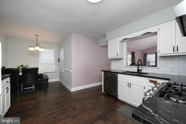 kitchen with a sink, stainless steel dishwasher, decorative backsplash, dark countertops, and dark wood finished floors