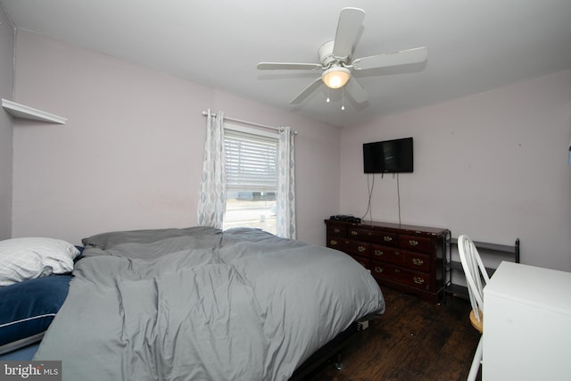 bedroom with dark wood-style flooring and a ceiling fan