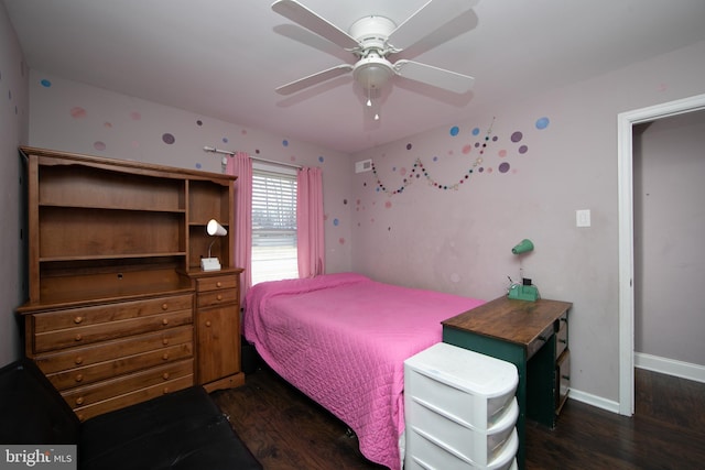 bedroom with ceiling fan, wood finished floors, and baseboards