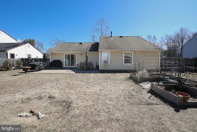 back of house with a garden, fence, and a patio