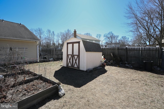 view of shed with a garden and a fenced backyard