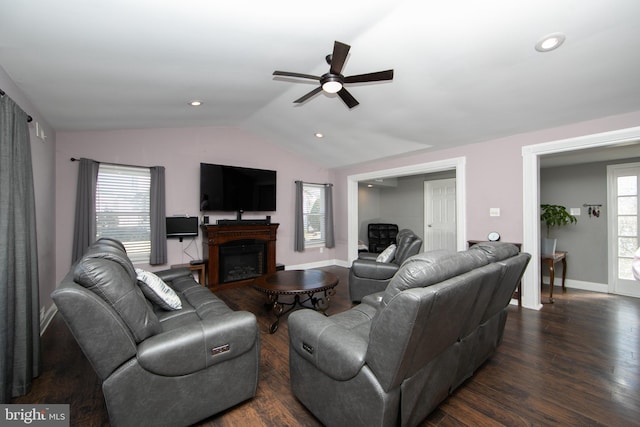 living area featuring a fireplace, lofted ceiling, recessed lighting, dark wood-type flooring, and baseboards