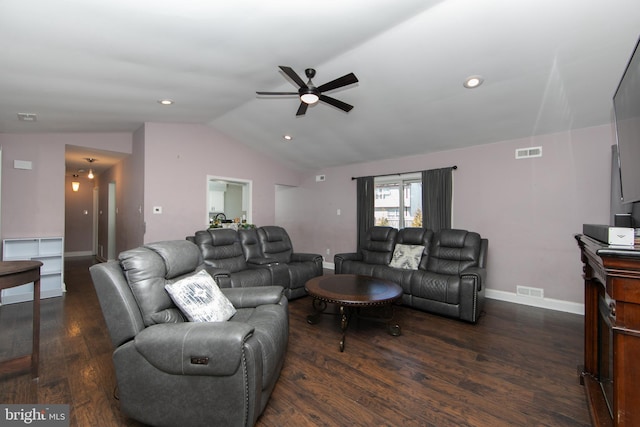 living room with dark wood-type flooring, visible vents, vaulted ceiling, and baseboards