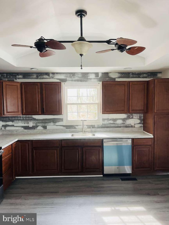 kitchen featuring dishwasher, ceiling fan, vaulted ceiling, and a sink