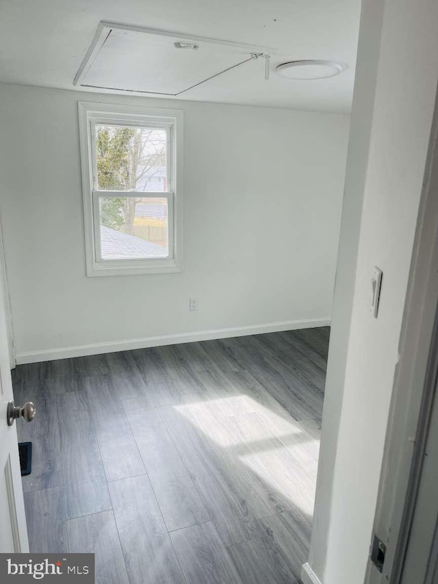 empty room featuring baseboards and wood finished floors