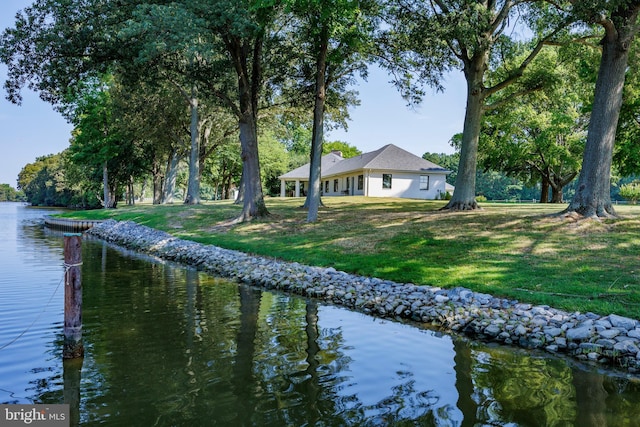 exterior space with a water view and a yard