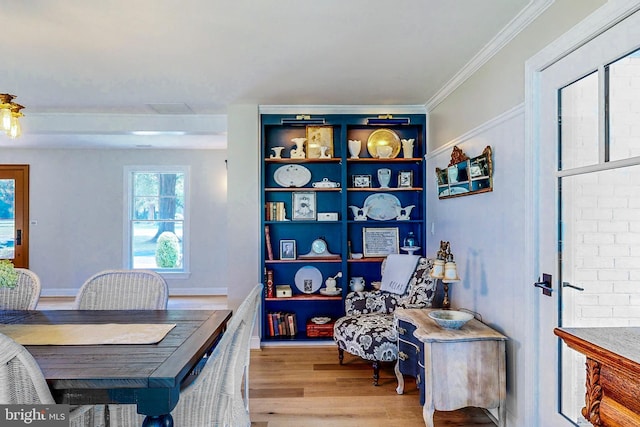 office space with light wood-type flooring and crown molding