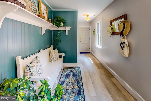 mudroom featuring wood finished floors and baseboards