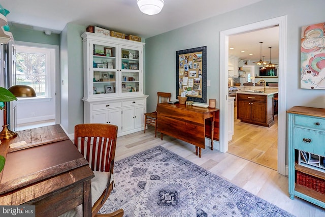 interior space with baseboards and light wood finished floors